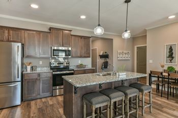 Kitchen with stainless steel appliances and bar